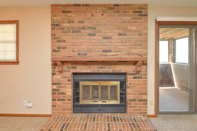 interior details with carpet floors, baseboards, and a fireplace
