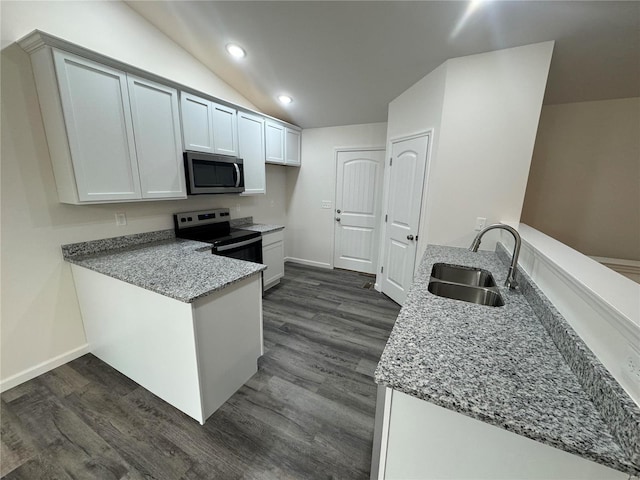 kitchen with light stone counters, a sink, electric stove, a peninsula, and stainless steel microwave