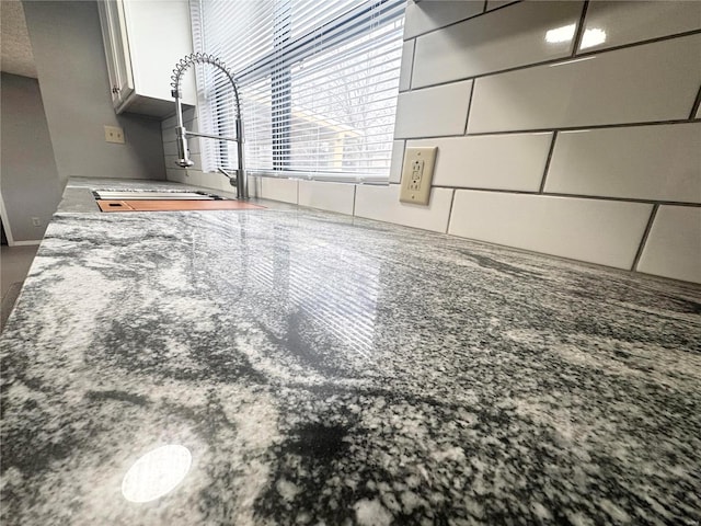 unfurnished living room with a sink