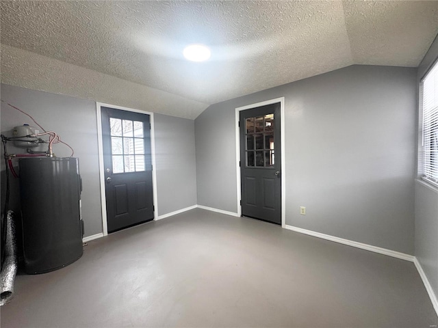entryway with water heater, baseboards, and vaulted ceiling