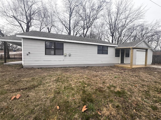 manufactured / mobile home featuring a garage and a front yard