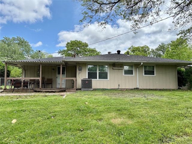 back of property with a yard, a deck, and central air condition unit