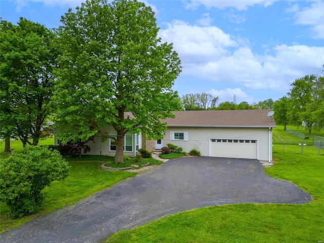 view of front of home with a garage, fence, a front yard, and aphalt driveway