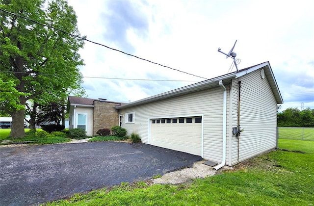 view of home's exterior featuring a yard and driveway