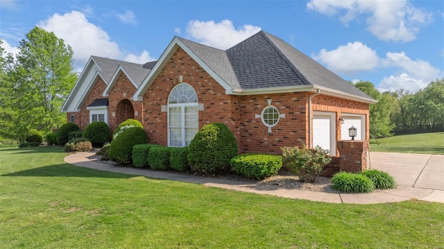 view of front of property featuring a garage, a front lawn, roof with shingles, brick siding, and concrete driveway