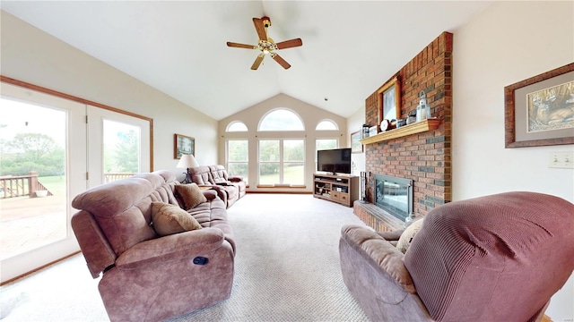 living area featuring carpet floors, a ceiling fan, a brick fireplace, and lofted ceiling