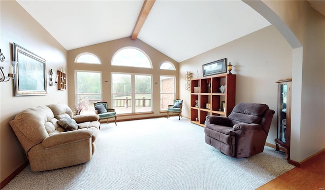 living room with arched walkways, baseboards, vaulted ceiling with beams, and wood finished floors
