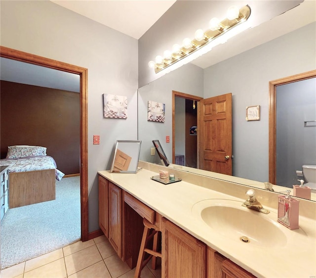 bathroom with toilet, tile patterned flooring, and vanity