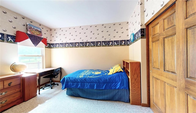 bedroom with baseboards and carpet