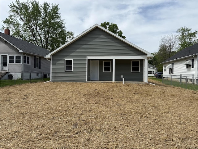 rear view of property with fence
