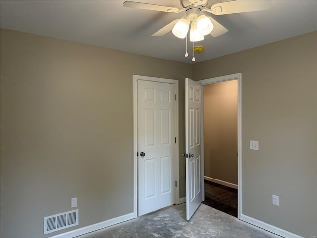 unfurnished bedroom featuring a ceiling fan, baseboards, visible vents, and concrete floors