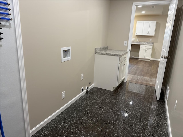 washroom featuring baseboards, washer hookup, cabinet space, and electric dryer hookup