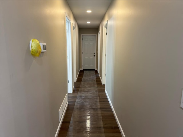 hall with baseboards, visible vents, recessed lighting, and dark wood-type flooring