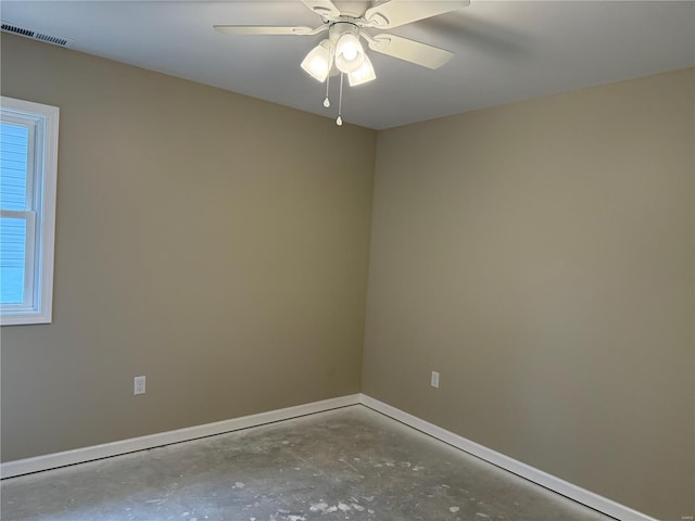spare room with visible vents, baseboards, concrete flooring, and a wealth of natural light