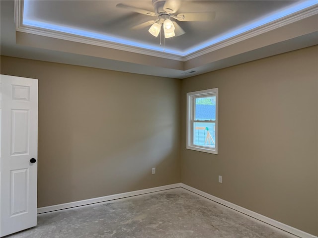 unfurnished room featuring a ceiling fan, visible vents, a raised ceiling, concrete floors, and ornamental molding