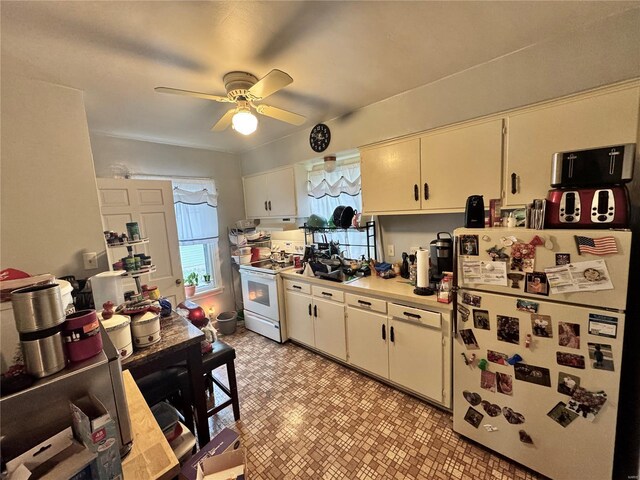 kitchen with white appliances, light countertops, a ceiling fan, white cabinetry, and light floors