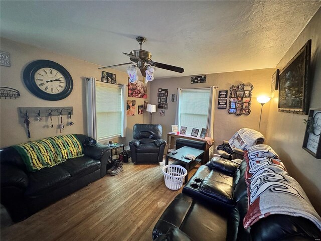 living area with ceiling fan and wood finished floors