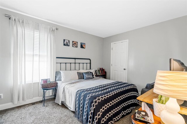 carpeted bedroom with baseboards