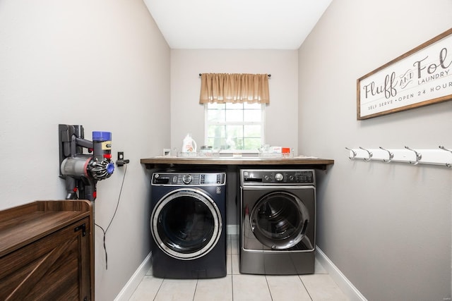 laundry room with baseboards, separate washer and dryer, laundry area, and tile patterned floors
