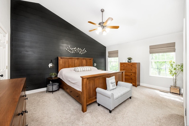 bedroom with light colored carpet, lofted ceiling, and multiple windows