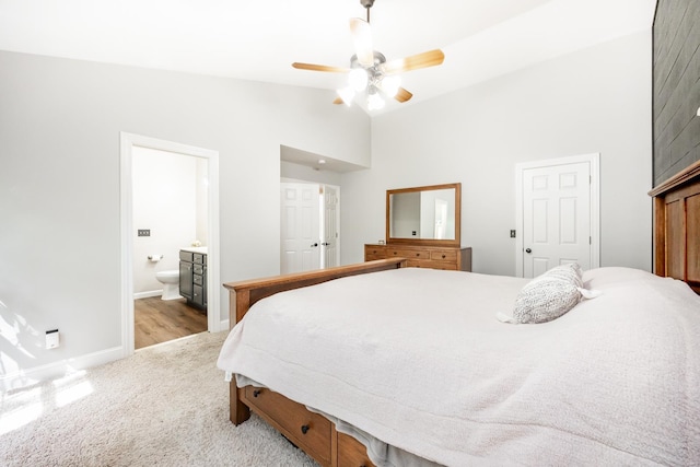 bedroom with a ceiling fan, baseboards, high vaulted ceiling, connected bathroom, and carpet flooring