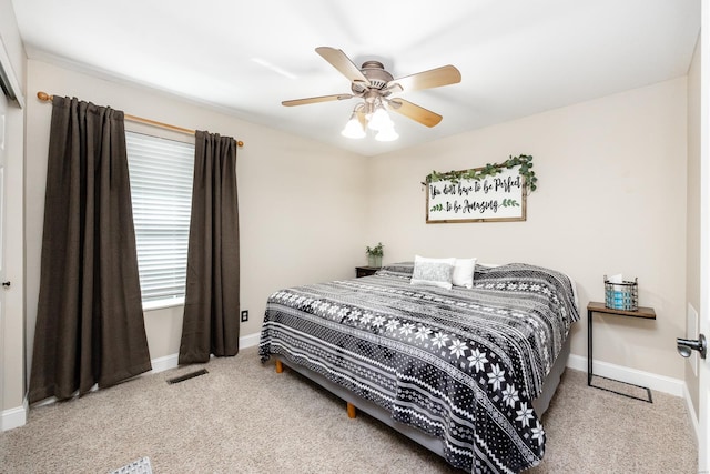carpeted bedroom with baseboards, ceiling fan, and visible vents