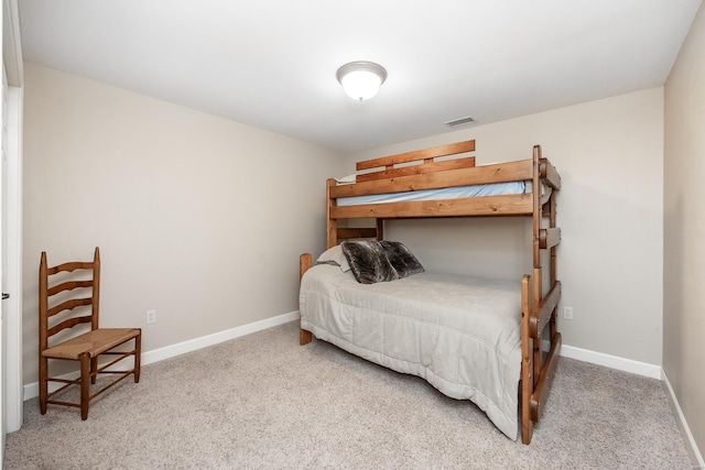 bedroom with carpet floors, baseboards, and visible vents