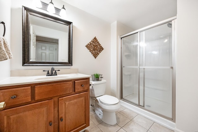 bathroom featuring toilet, a shower stall, tile patterned flooring, and vanity