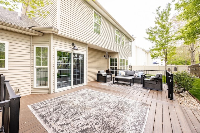 wooden deck featuring outdoor lounge area and fence