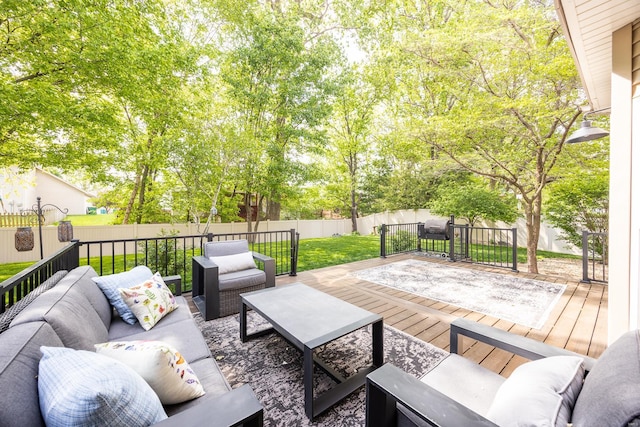 deck with a yard, an outdoor living space, and a fenced backyard