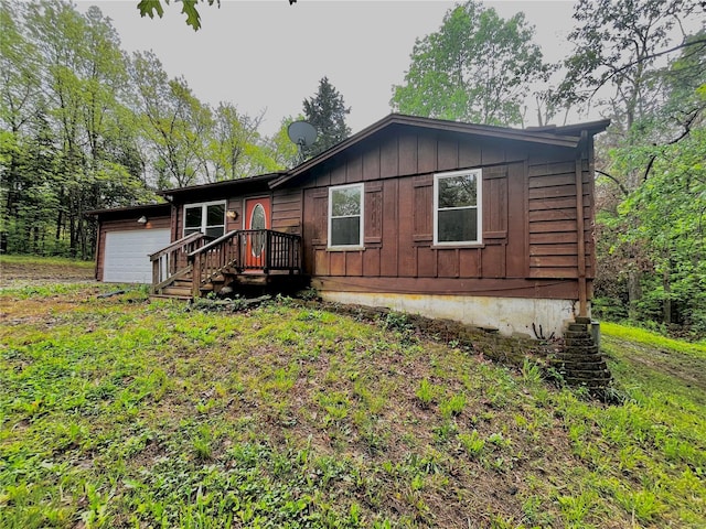 view of front facade with an attached garage and board and batten siding