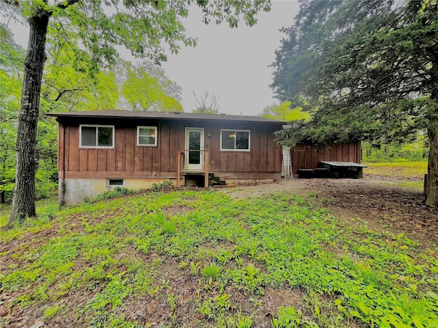 rear view of house featuring entry steps