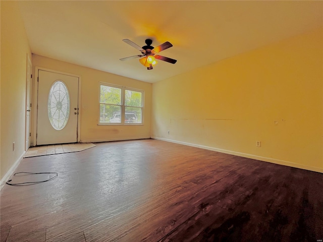 foyer featuring baseboards, ceiling fan, and wood finished floors