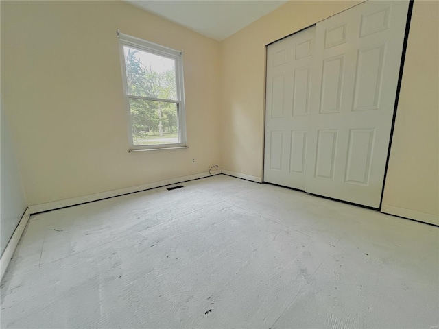 unfurnished bedroom with baseboards and visible vents