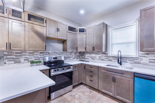 kitchen with a sink, dishwasher, light countertops, stainless steel range with electric stovetop, and backsplash