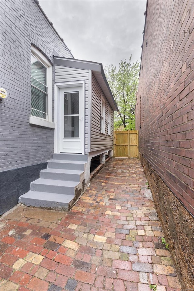 view of side of property with entry steps and fence