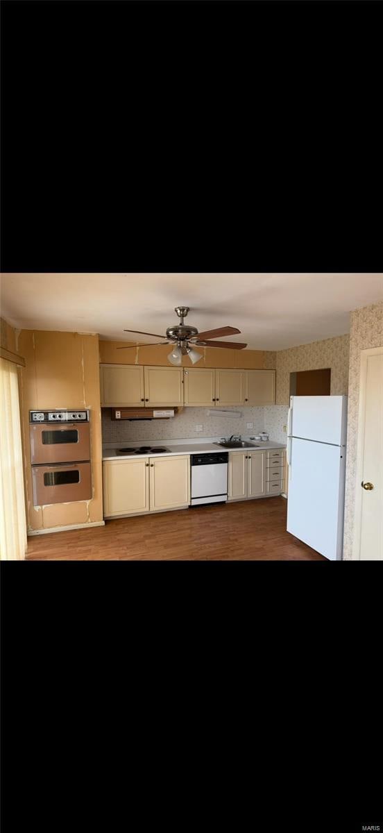 kitchen featuring wood finished floors, ceiling fan, and white appliances