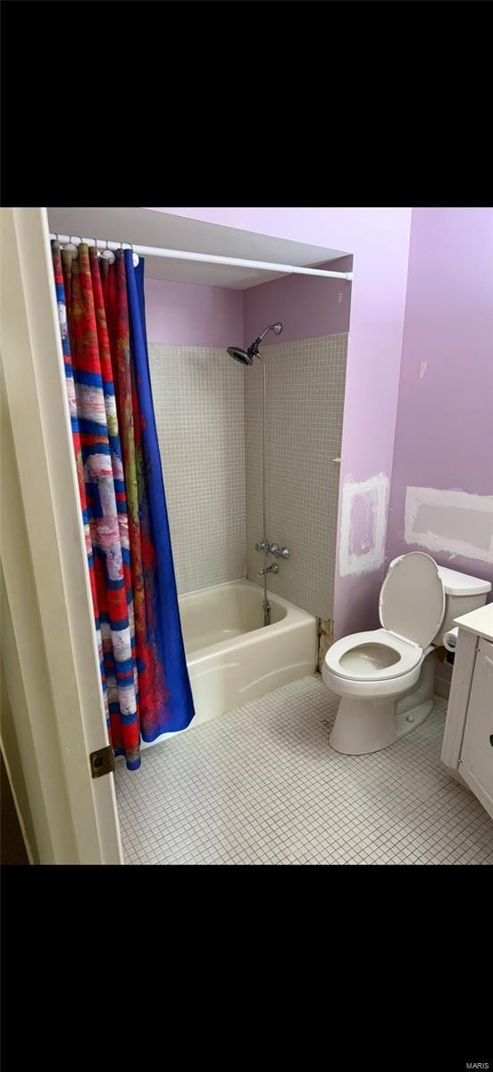 full bath featuring toilet, shower / tub combo with curtain, tile patterned floors, and vanity