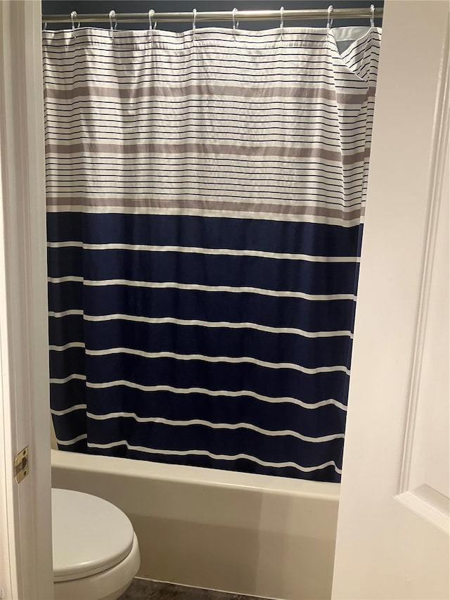 bathroom with shower / bathtub combination with curtain and toilet