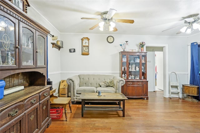 living area with light wood finished floors and ceiling fan