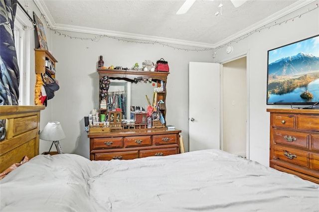 bedroom with crown molding, ceiling fan, and a textured ceiling