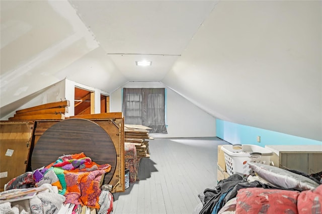 bedroom featuring vaulted ceiling and hardwood / wood-style floors