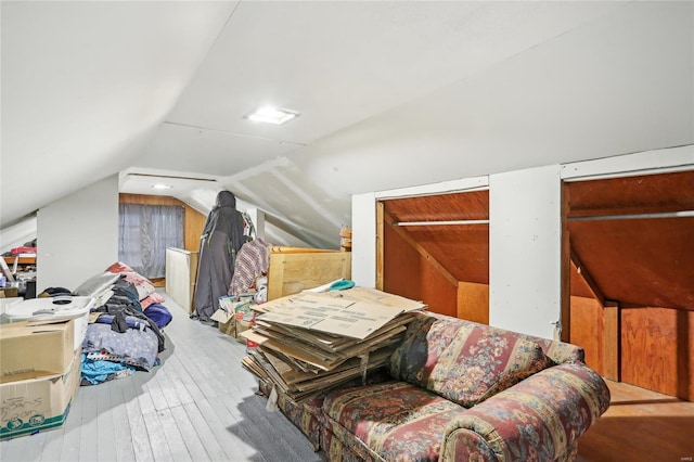 additional living space featuring lofted ceiling and hardwood / wood-style floors