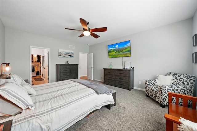 carpeted bedroom featuring visible vents, baseboards, and ceiling fan