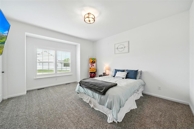bedroom with carpet floors and baseboards
