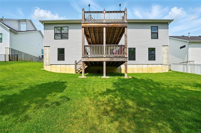 back of house with fence, a yard, and a deck