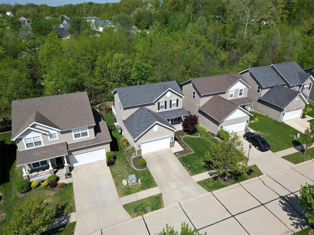 birds eye view of property with a residential view and a view of trees