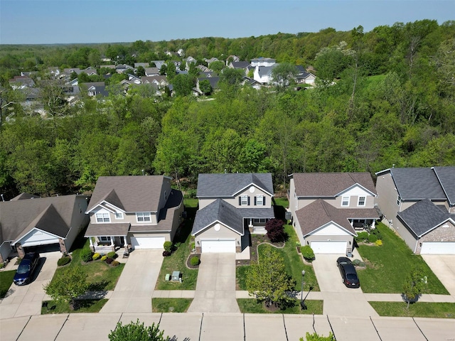 drone / aerial view with a forest view and a residential view