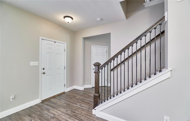 entrance foyer with baseboards, stairs, and wood finished floors