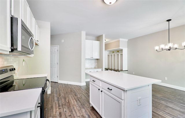 kitchen with baseboards, backsplash, stainless steel appliances, and dark wood finished floors